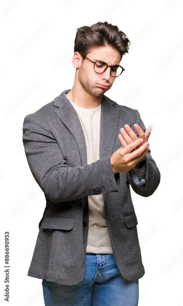 Young business man wearing glasses over isolated background Suffering pain on hands and fingers, arthritis inflammation
