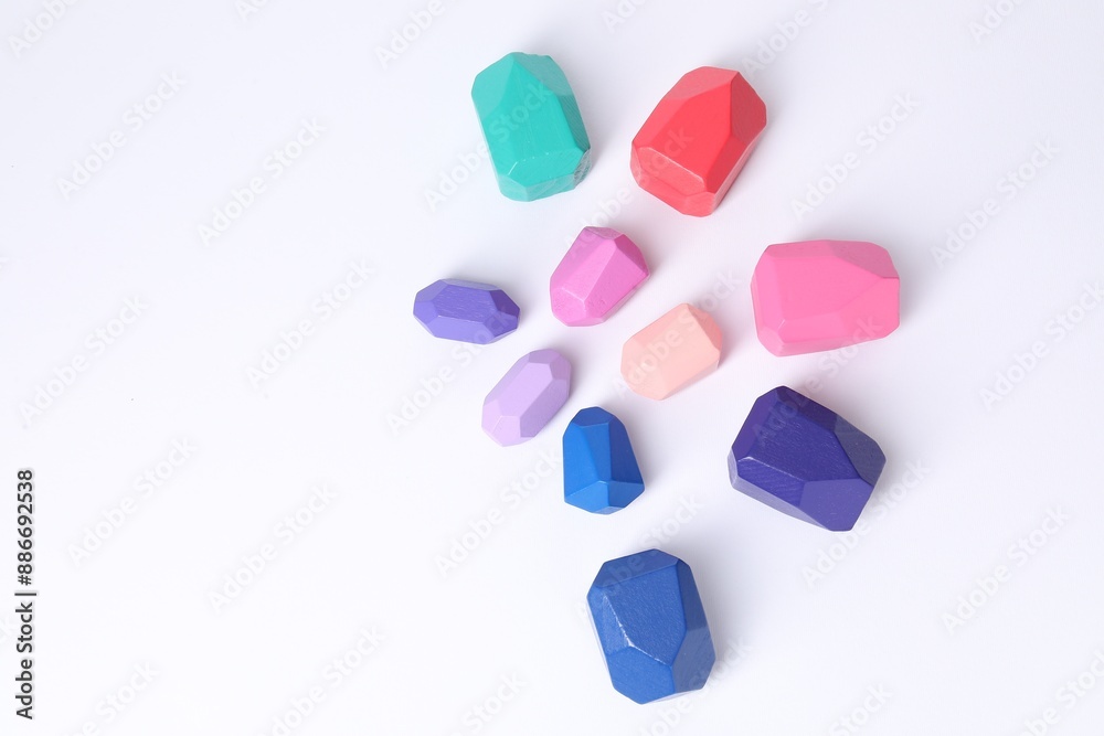 Many colorful balancing stones on white background, flat lay. Space for text Many colorful balancing stones on white background, flat lay. Space for text