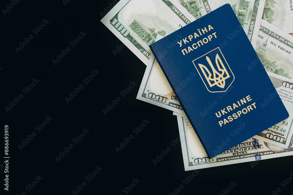 Biometric Ukrainian passport and money on a black background, copy space. Biometric Ukrainian passport and money on a black background, copy space.