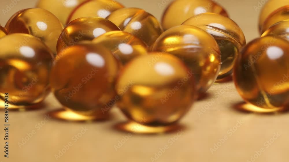 Close-up of yellow omega 3 gel capsule,Fish oil supplement,vitamin E,Concept of Healthy Living,4k footage Close-up of yellow omega 3 gel capsule,Fish oil supplement,vitamin E,Concept of Healthy Living,4k footage