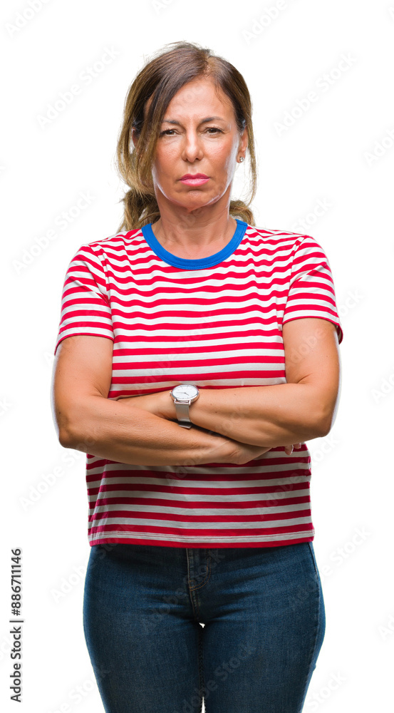 Middle age senior hispanic woman over isolated background skeptic and nervous, disapproving expression on face with crossed arms. Negative person. Middle age senior hispanic woman over isolated background skeptic and nervous, disapproving expression on face with crossed arms. Negative person.