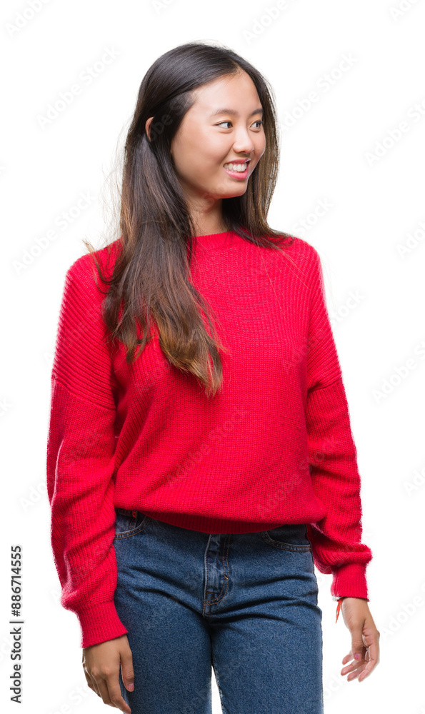 Young asian woman wearing winter sweater over isolated background looking away to side with smile on face, natural expression. Laughing confident. Young asian woman wearing winter sweater over isolated background looking away to side with smile on face, natural expression. Laughing confident.