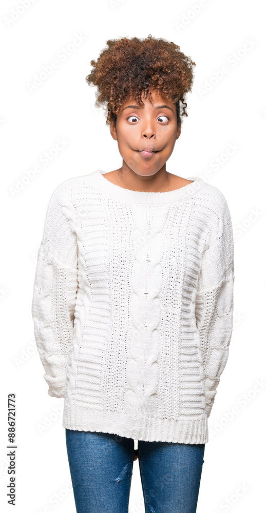 Beautiful young african american woman wearing winter sweater over isolated background making fish face with lips, crazy and comical gesture. Funny expression. Beautiful young african american woman wearing winter sweater over isolated background making fish face with lips, crazy and comical gesture. Funny expression.