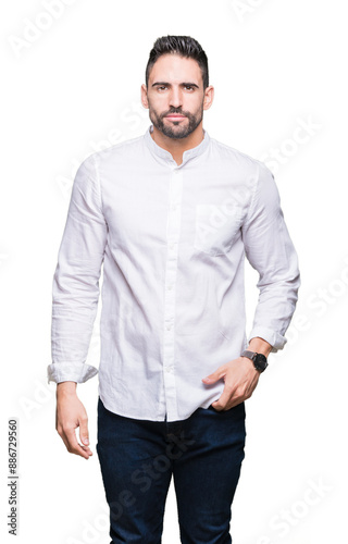 Young business man over isolated background Relaxed with serious expression on face. Simple and natural looking at the camera.