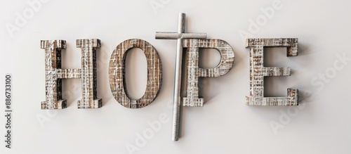 Silver cross added to wooden block letters spelling out Hope on a white background with copy space image