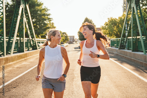 Canvastavla Two athletic women in sportswear is jogging together