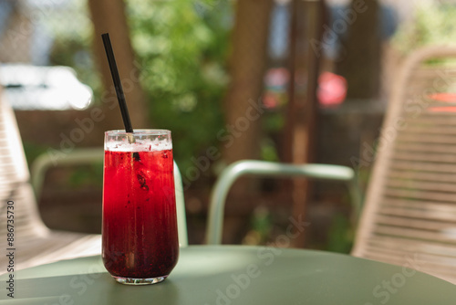 Close-up of a fruit lemonade drink on a cafe table outdoors in summer