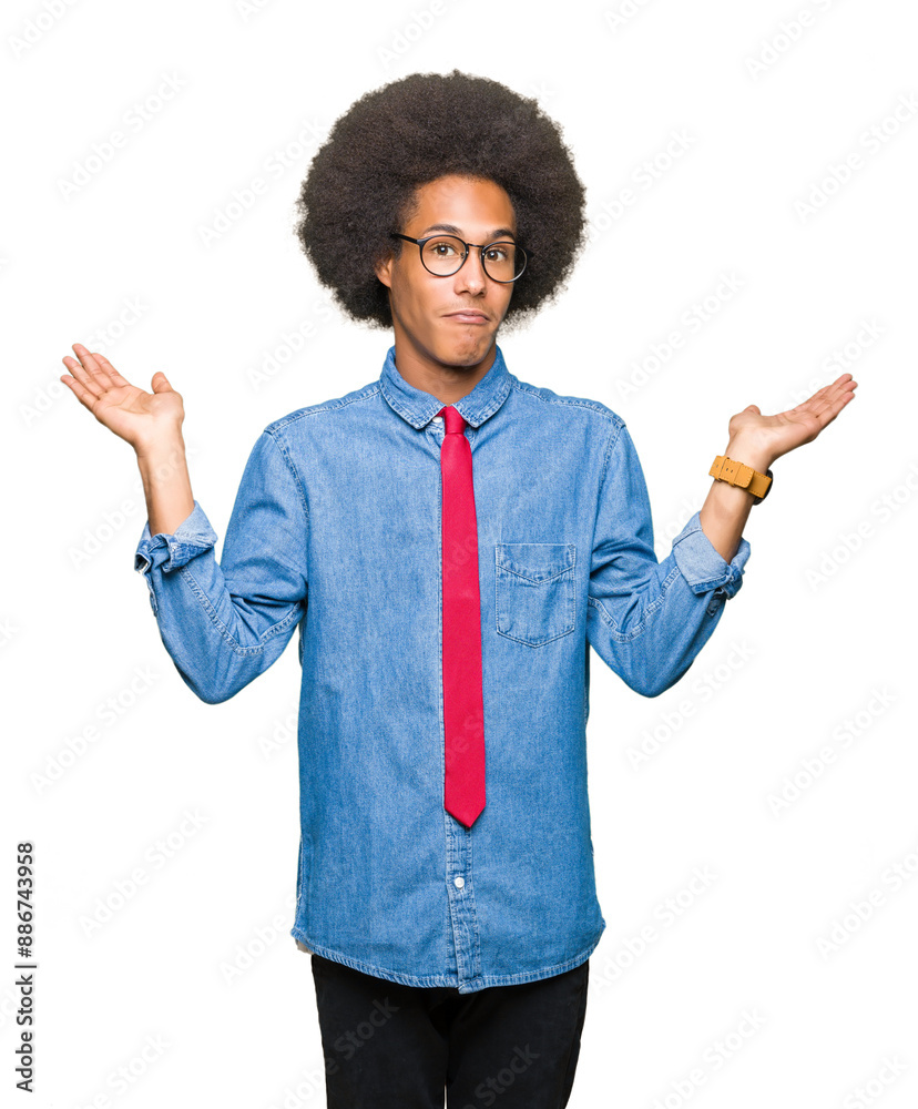 Young african american business man with afro hair wearing glasses and red tie clueless and confused expression with arms and hands raised. Doubt concept. Young african american business man with afro hair wearing glasses and red tie clueless and confused expression with arms and hands raised. Doubt concept.