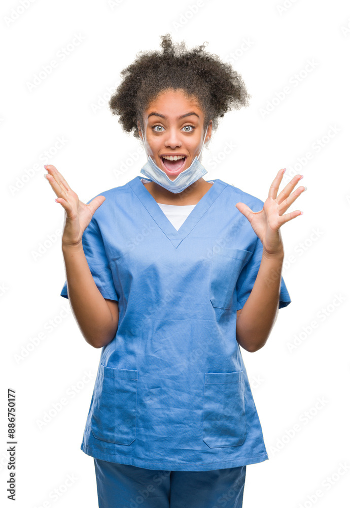 Φωτογραφία Young afro american doctor woman over isolated background celebrating crazy and amazed for success with arms raised and open eyes screaming excited