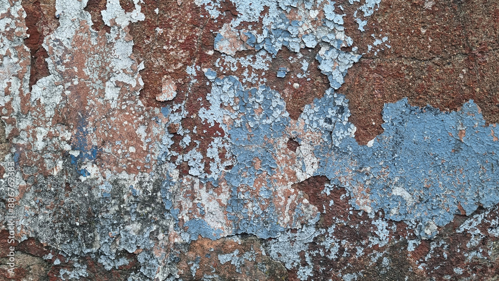 Texture of old rustic wall covered with gray and blue stucco. Multilayers of old paint on the wall. Textured background. Selective focus Texture of old rustic wall covered with gray and blue stucco. Multilayers of old paint on the wall. Textured background. Selective focus