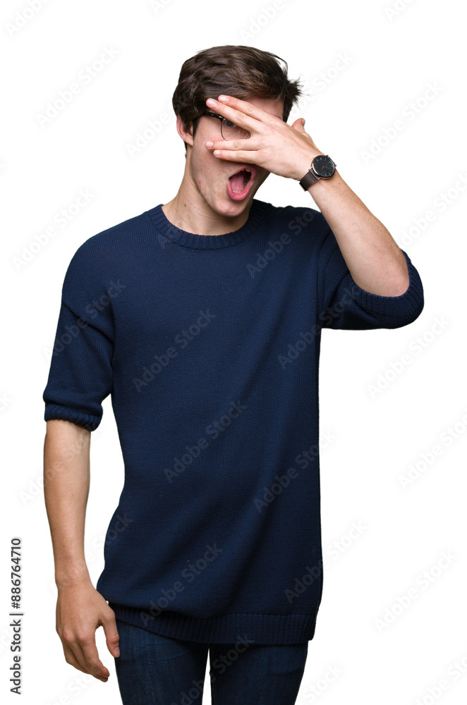 Young handsome man wearing glasses over isolated background peeking in shock covering face and eyes with hand, looking through fingers with embarrassed expression. Young handsome man wearing glasses over isolated background peeking in shock covering face and eyes with hand, looking through fingers with embarrassed expression.