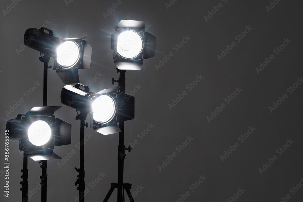 Dark photo background and professional lighting equipment in studio. Space for text Dark photo background and professional lighting equipment in studio. Space for text