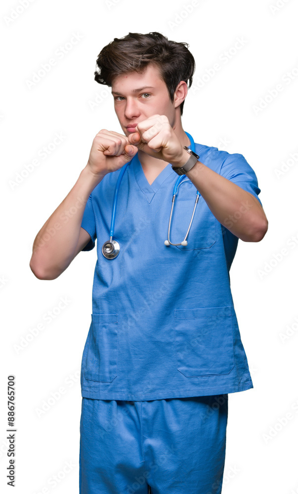 Young doctor wearing medical uniform over isolated background Punching fist to fight, aggressive and angry attack, threat and violence Young doctor wearing medical uniform over isolated background Punching fist to fight, aggressive and angry attack, threat and violence