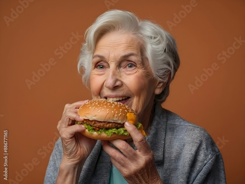 Portrait of an old woman, a grandmother, orange background with copy space