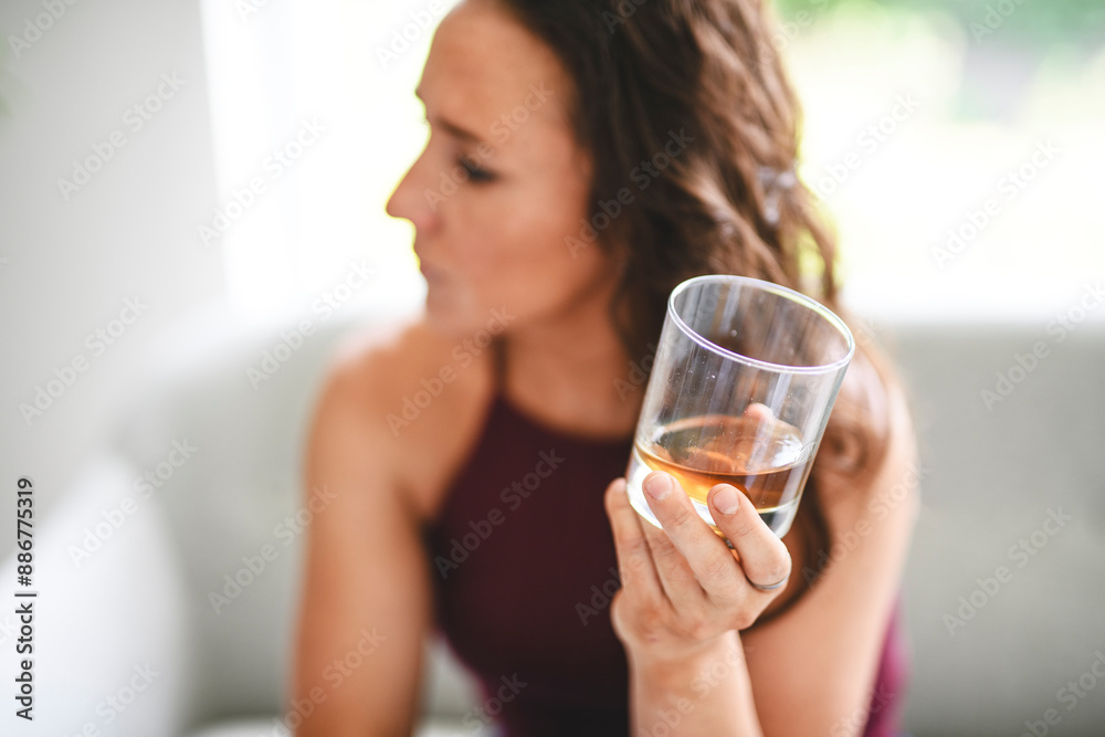 alone depressed woman drink booze on sofa at home. Treatment of alcohol addiction, suffer abuse problem alcoholism. alone depressed woman drink booze on sofa at home. Treatment of alcohol addiction, suffer abuse problem alcoholism.