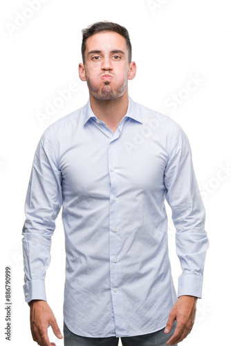 Handsome young businessman puffing cheeks with funny face. Mouth inflated with air, crazy expression.