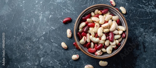 A bowl of uncooked white and red organic beans for a healthy eating concept, shot from above with room for text or images. photo