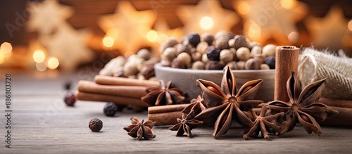 Close-up Christmas decorations featuring wooden stars and spices on a bright background with copy space image.