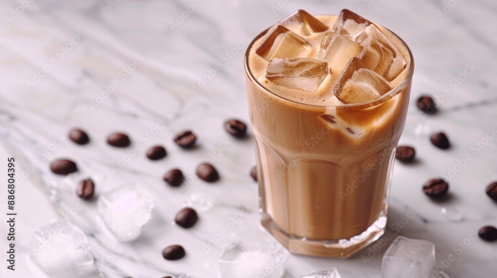 trendy concept an iced latte in a glass on a marble surface, with ice cubes perfect for text placement in photos