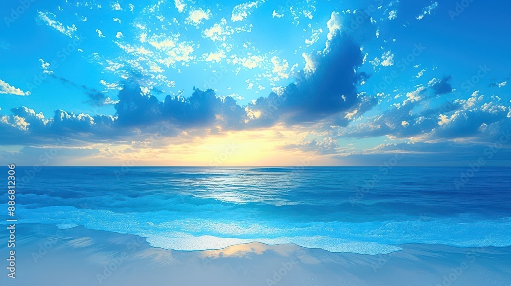Obraz premium Stunning beach sunrise with gentle waves and a brilliant blue sky filled with clouds. 