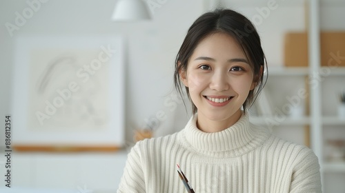 Asian artist smiling while sketching in a serene studio representing creative passion and happiness in art Portrait, Realistic Photo, High resolution, Half-body picture, Minimalism,