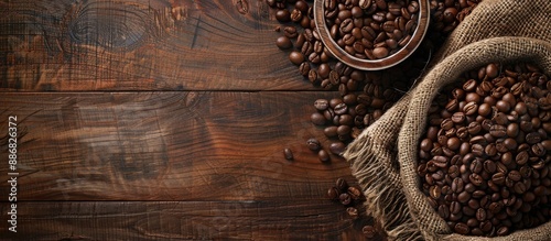 A rustic wooden table set with roasted coffee beans, offering an ideal background for text in a copy space image.