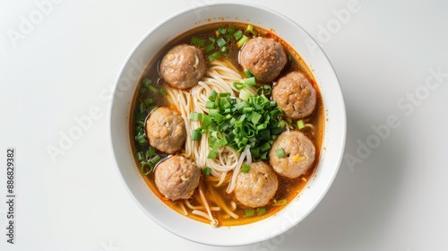 A bowl of soup with meatballs and noodles