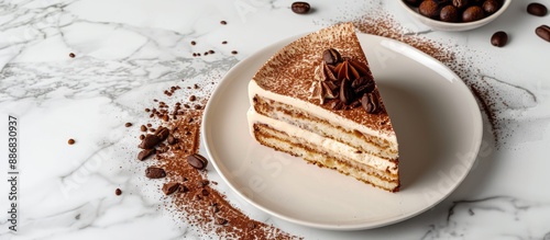 Homemade Tiramisu cake dessert displayed on a white marble background with ample copy space image. photo