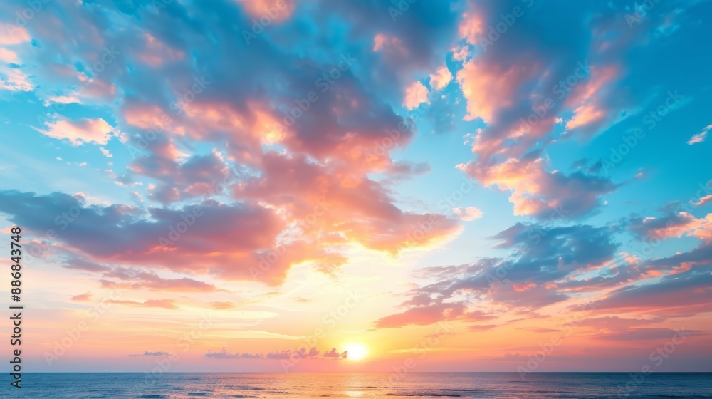 Obraz premium The sun sets over the ocean, painting the water with hues of orange and red A solitary boat dots the distance, while clouds tinted with pastel shades dot the
