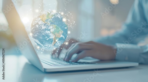 Wallpaper Mural A person is typing on a laptop with a globe in the background Torontodigital.ca