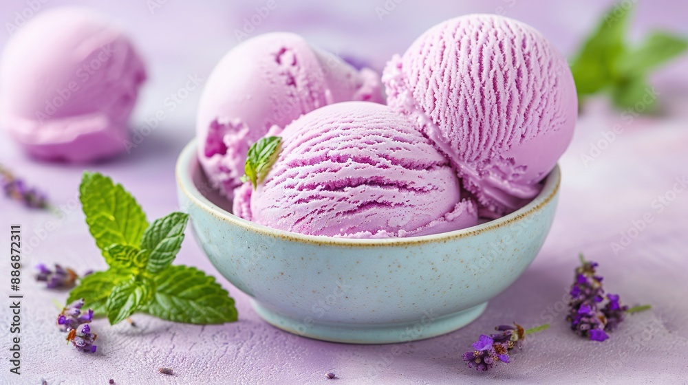 Three scoops of ice cream served in a bowl alongside a fresh mint sprig Three scoops of ice cream served in a bowl alongside a fresh mint sprig