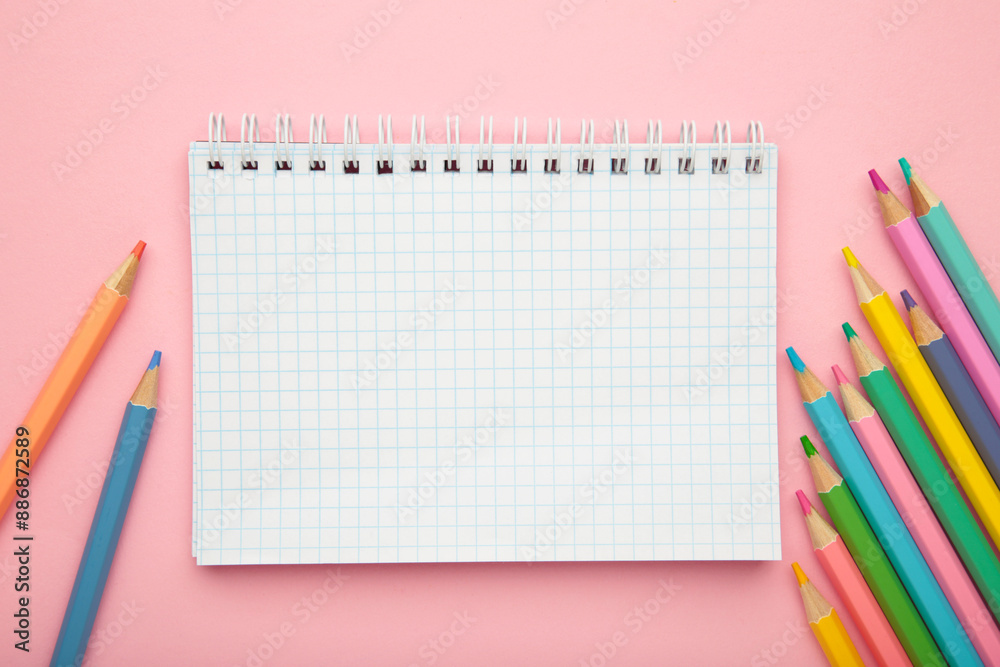 School supplies concept. Open notebook with colorful pencil School supplies concept. Open notebook with colorful pencil