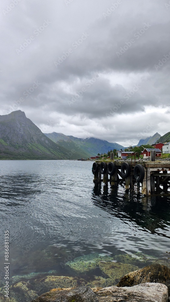 Fototapeta premium Nordic fishing village by the sea near mountains