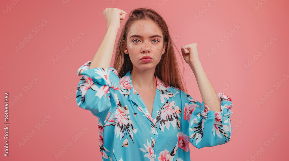 portrait of a woman raising hands in front of pink background portrait of a woman raising hands in front of pink background