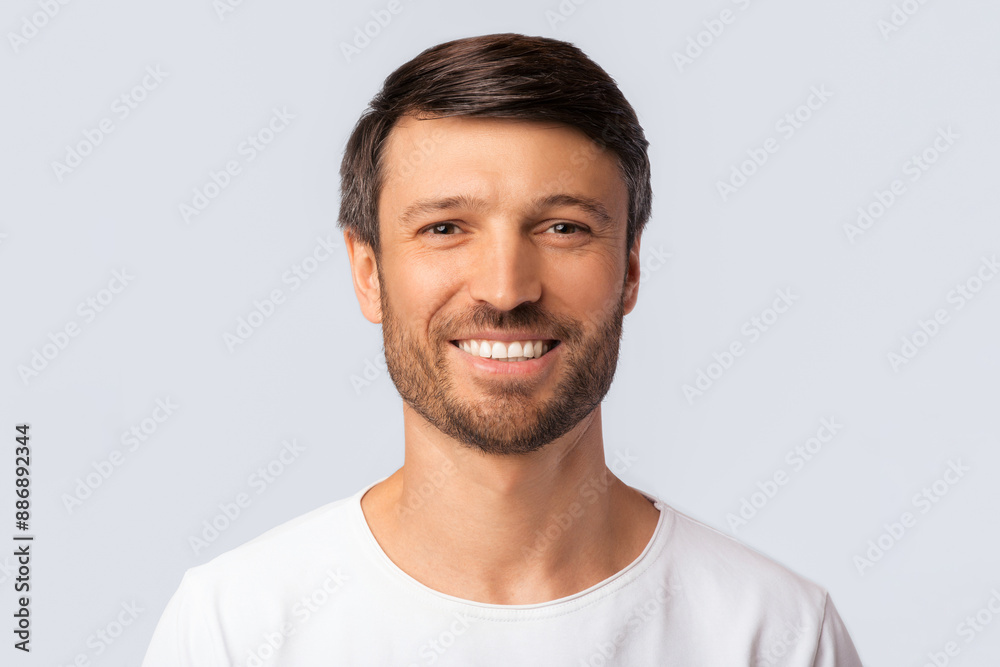 Portrait Of Cheerful Man Smiling At Camera Over White Background In Studio. Isolated Portrait Of Cheerful Man Smiling At Camera Over White Background In Studio. Isolated