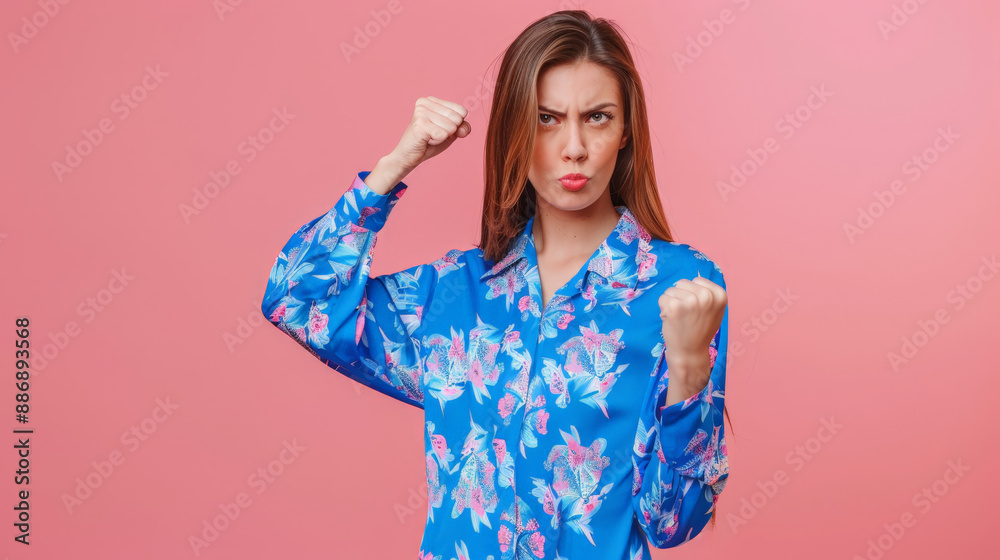 portrait of a woman raising hands in front of pink background