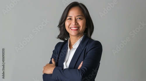 Obraz na płótnie Confident MiddleAged Filipino Businesswoman Standing with Arms Crossed, Professional Portrait for Business and Career Use w salonie