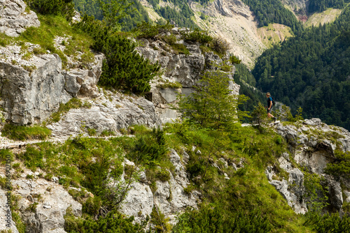 Begunjščica panorama of mountain trekking to the highest peak. View of the Alps, climbing with via ferrata. Distant view of Lake Bled from above. Sports holidays, life of adventure in the countryside. photo