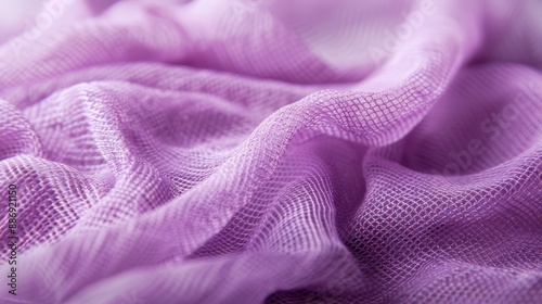  A tight shot of a purplish fabric, its upper and lower parts featuring a hazy, patterned design