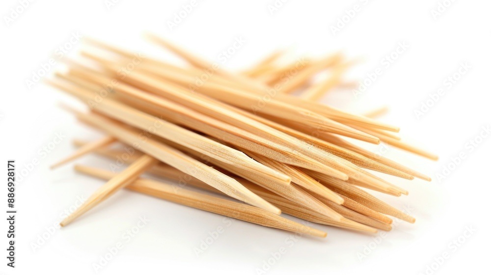 A stack of wooden toothpicks arranged on a white surface, ideal for use as props or decorative elements A stack of wooden toothpicks arranged on a white surface, ideal for use as props or decorative elements