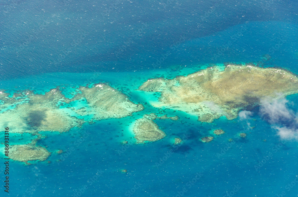 Spectacular aerial view on Great Barrier Reef on the way from Cairns to Lizard Island, Queensland, Australia. Great Barrier Reef is the worlds largest coral reef system. Spectacular aerial view on Great Barrier Reef on the way from Cairns to Lizard Island, Queensland, Australia. Great Barrier Reef is the worlds largest coral reef system.