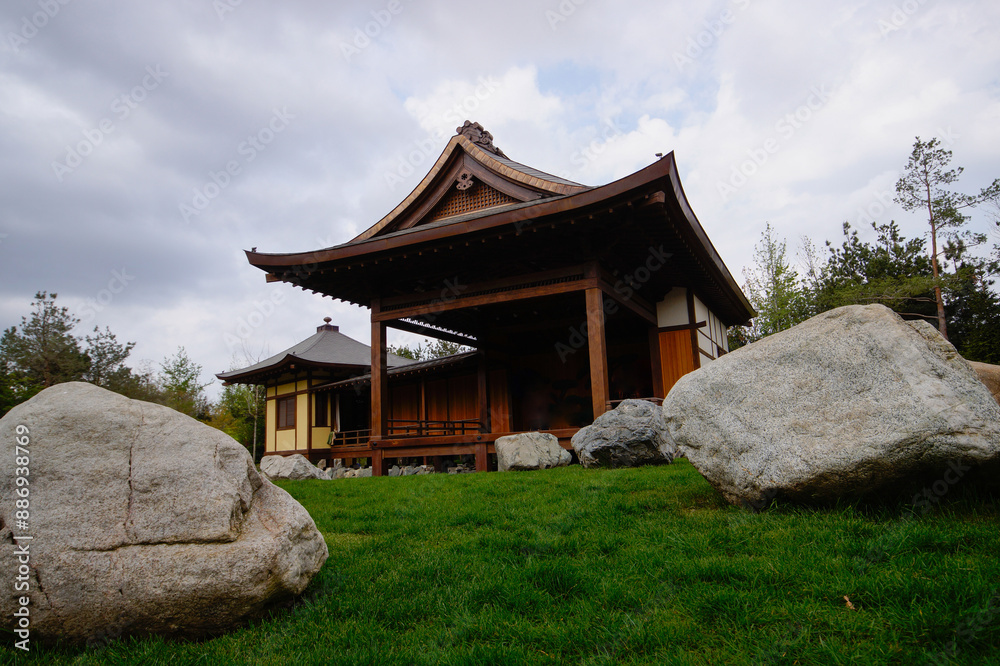 A beautiful Japanese garden with a pond and Tahoto Pagoda in the distance. Japanese garden in the public park of the city of Krasnodar, Russia.