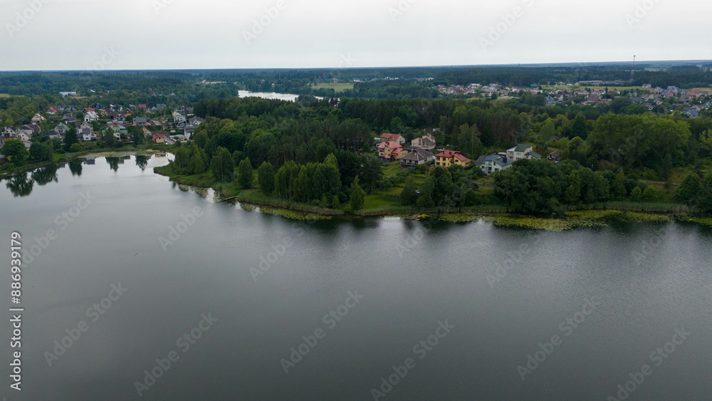 Fototapeta premium Drone photography of small town surrounded by lakes during summer day