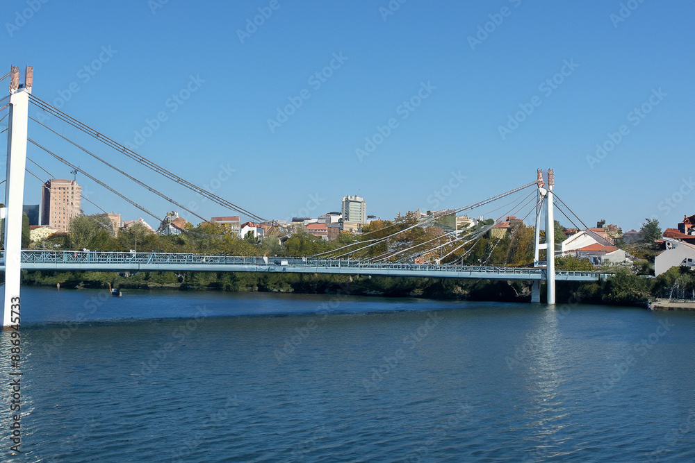 Obraz premium Movement of people and communication between cities. Travel landscape concept. A city stands on water under bridge. A bridge stands in water between cities to facilitate lifestyle communication 