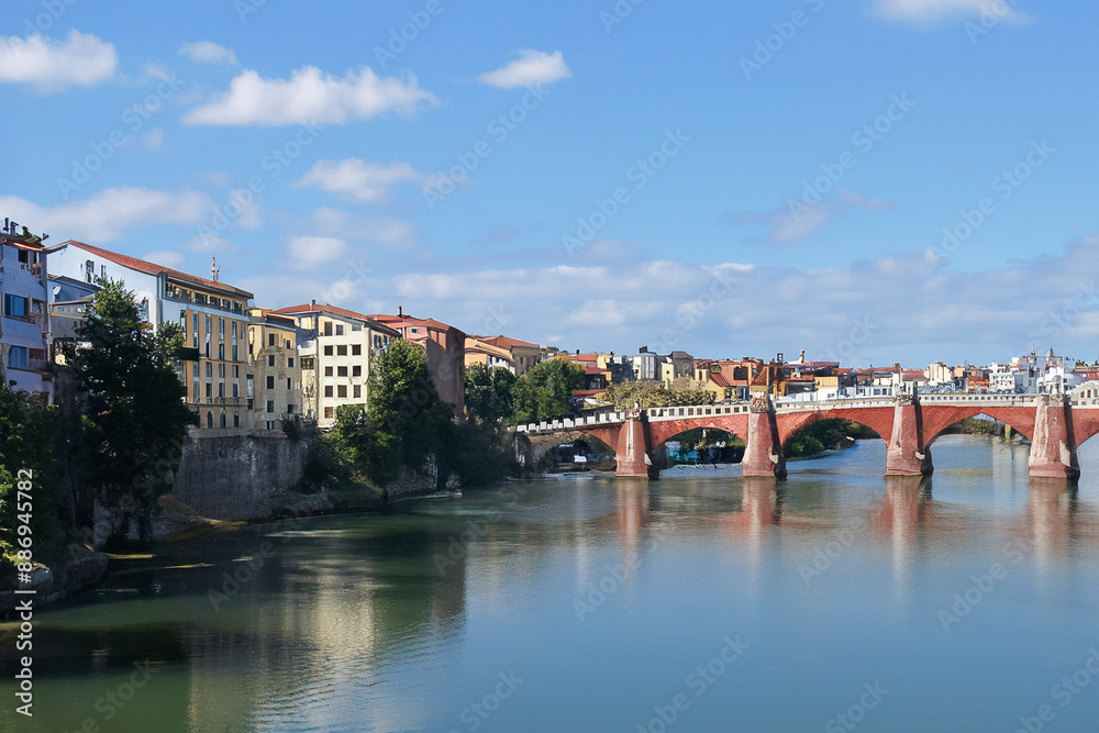 Fototapeta premium Movement of people and communication between cities. Travel landscape concept. A city stands on water under bridge. A bridge stands in water between cities to facilitate communication lifestyle