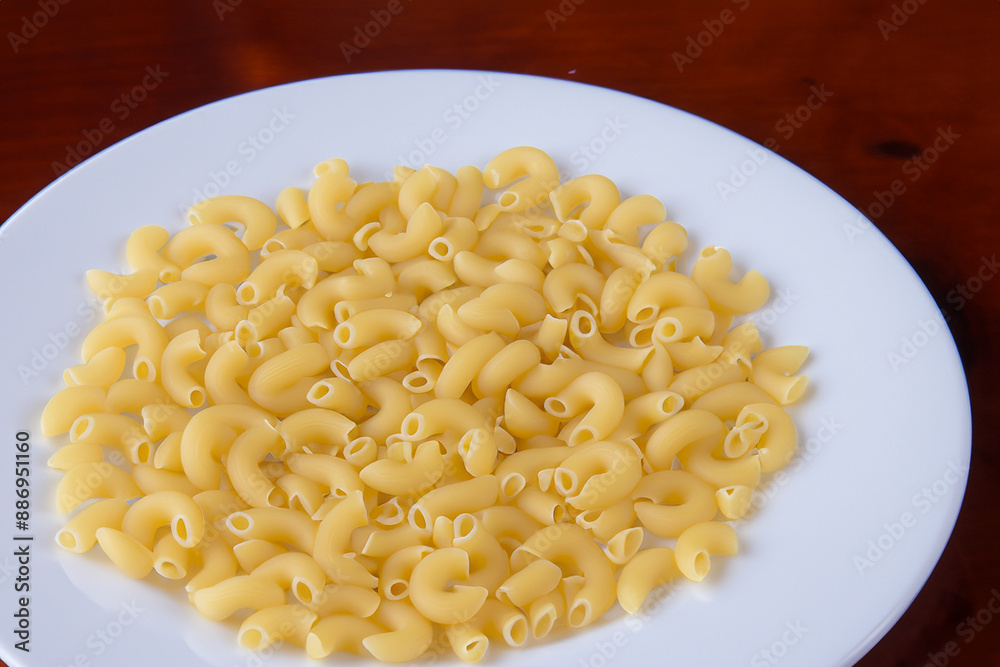 Pasta is a healthy food with lots of nutrients. Fresh dish vegetable concept. A white plate with pasta and a ham is lying on it. White food with nutrients lies on a plate lifestyle. Pasta is a healthy food with lots of nutrients. Fresh dish vegetable concept. A white plate with pasta and a ham is lying on it. White food with nutrients lies on a plate lifestyle.