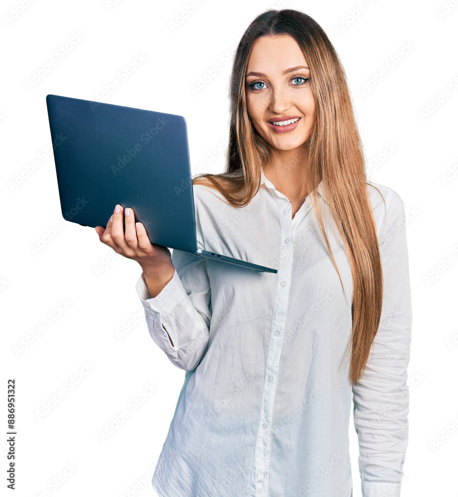 Beautiful caucasian woman working using computer laptop looking positive and happy standing and smiling with a confident smile showing teeth Beautiful caucasian woman working using computer laptop looking positive and happy standing and smiling with a confident smile showing teeth