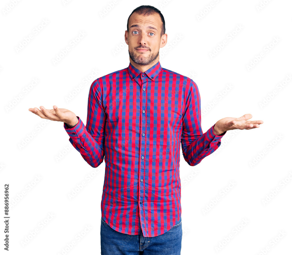 Young handsome man wearing casual clothes clueless and confused expression with arms and hands raised. doubt concept. Young handsome man wearing casual clothes clueless and confused expression with arms and hands raised. doubt concept.