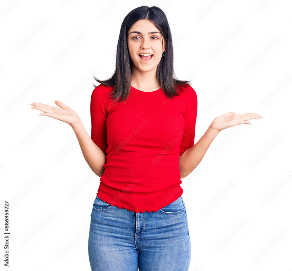 Young beautiful girl wearing casual t shirt celebrating victory with happy smile and winner expression with raised hands Young beautiful girl wearing casual t shirt celebrating victory with happy smile and winner expression with raised hands