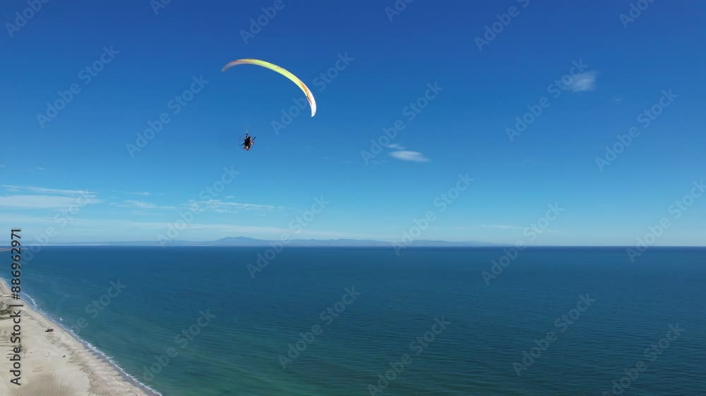 Powered paragliding in Greece near Meteora on the coast line over beautiful sandy beaches, paramotor flying in a see breeze,aerial panorama landscape view of Greek nature,outdoor concept Powered paragliding in Greece near Meteora on the coast line over beautiful sandy beaches, paramotor flying in a see breeze,aerial panorama landscape view of Greek nature,outdoor concept